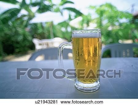 Beer mug on table outdoors, Taketomijima, Okinawa Prefecture, Japan View Large Photo Image Stock Image - Beer mug on table outdoors, Taketomijima, Okinawa Prefecture, Japan. Fotosearch