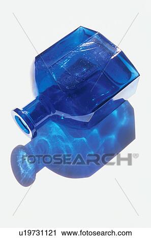 Blue glass bottle with shadow on white background View Large Photo Image Stock Image - Blue glass bottle with shadow on white background. Fotosearch