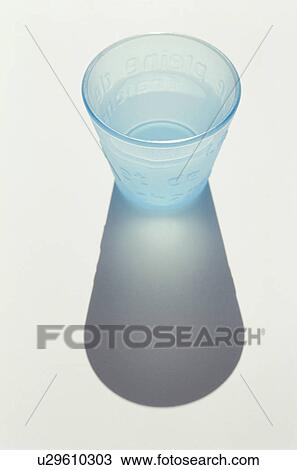 Stock Image - Blue glass of water on white background. Fotosearch