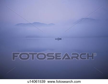 Stock Photo - Boat in a misty lake. Tochigi Prefecture, Japan. Fotosearch