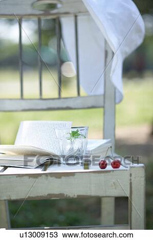 Book, glass, hat and cherries on chair View Large Photo Image Stock Image - Book, glass, hat and cherries on chair. Fotosearch