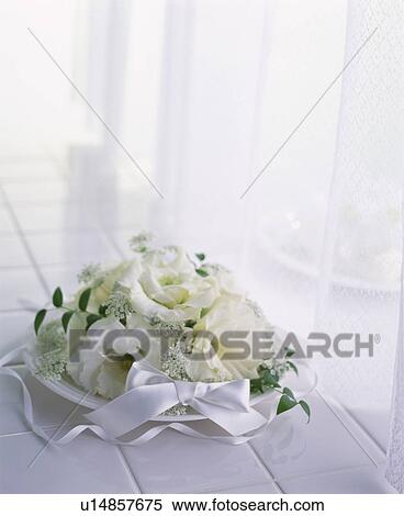 Stock Photography - Bouquet of white flowers on white tiles. Fotosearch