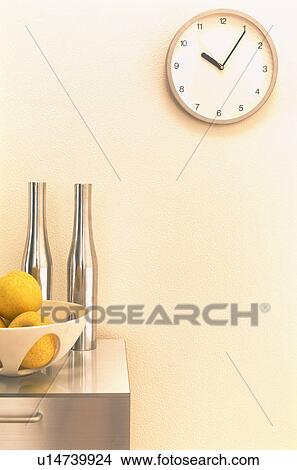 Bowl of grapefruit on metallic counter with clock on the wall View Large Photo Image Picture - Bowl of grapefruit on metallic counter with clock on the wall. Fotosearch