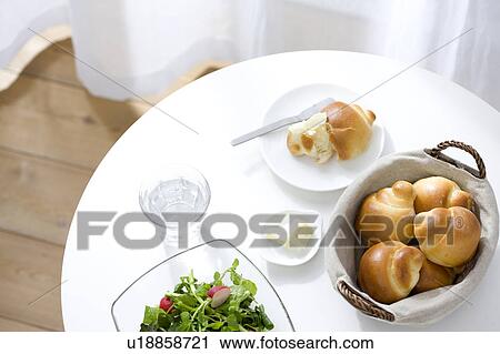 Stock Image - Bread and salad on a table. Fotosearch