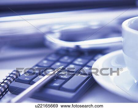 Stock Photo - Briefcase, notebook and pen, calculator and a coffee cup. Fotosearch