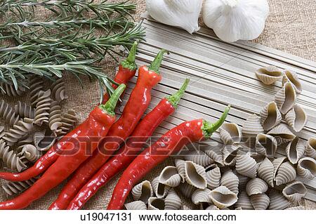 Stock Image - Buckwheat pasta, noodles, garlic, rosemary and chili peppers. Fotosearch