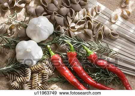Stock Photo - Buckwheat pasta, noodles, garlic, rosemary and chili peppers. Fotosearch
