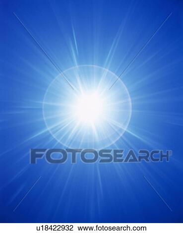 Stock Image - Burst of light on blue background. Fotosearch