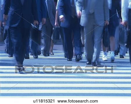 Stock Image - Business people crossing road. Fotosearch