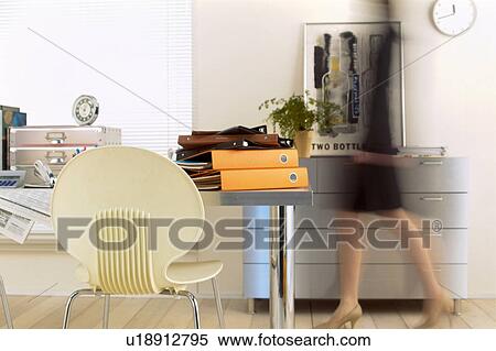 Stock Photography - Businesswoman walking in office. Fotosearch