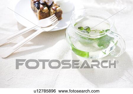 Stock Photograph - Cake and herbal tea. Fotosearch