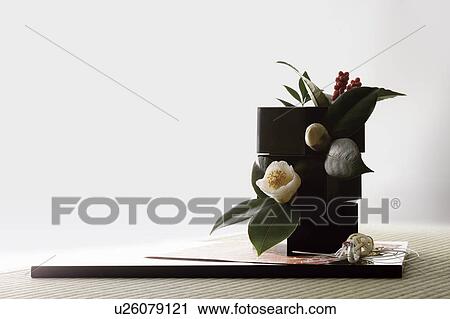Stock Image - Camellia and sarcandra glabra in boxes with a mizuhiki crane. Fotosearch