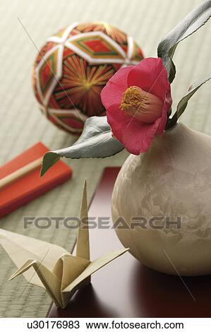 Camellia in a vase with paper crane and a temari ball View Large Photo Image Stock Image - Camellia in a vase with paper crane and a temari ball. Fotosearch