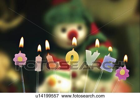 Stock Photo - Candles in front of snowman. Fotosearch