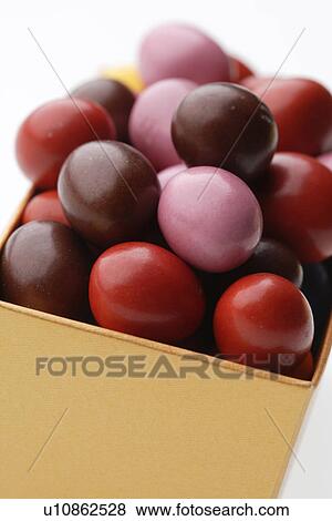 Candy covered chocolates in a box View Large Photo Image Stock Photo - Candy covered chocolates in a box. Fotosearch
