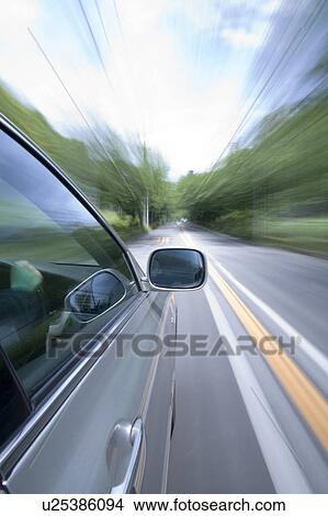 Car driving along a tree lined road View Large Photo Image Picture - Car driving along a tree lined road. Fotosearch