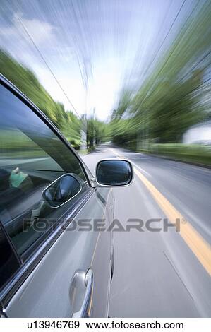 Car driving along a tree lined road View Large Photo Image Stock Photo - Car driving along a tree lined road. Fotosearch