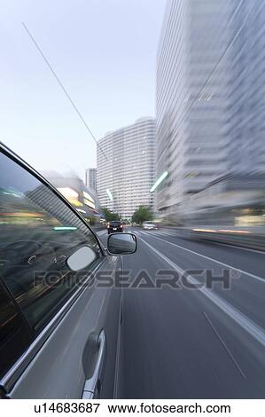 Stock Photo - Car driving through the city. Fotosearch