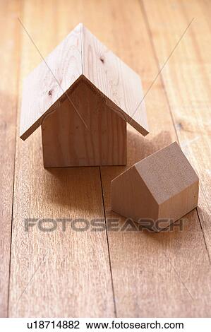 Stock Image - Carved wooden houses on a wooden floor. Fotosearch