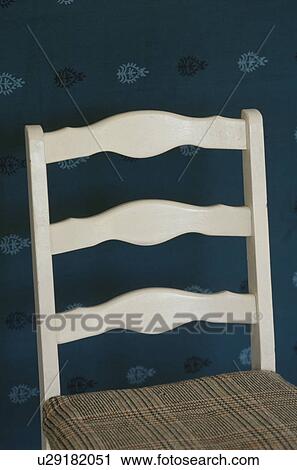 Chair against patterned wallpaper View Large Photo Image Stock Image - Chair against patterned wallpaper. Fotosearch