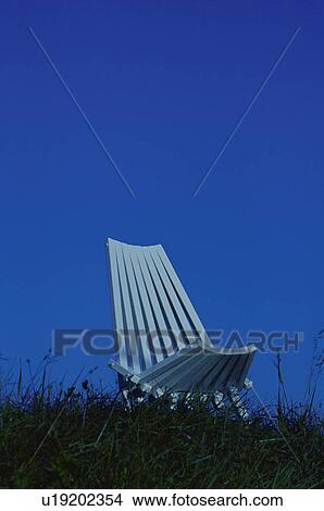 Chair in meadow against blue sky View Large Photo Image Picture - Chair in meadow against blue sky. Fotosearch