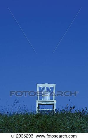 Chair in meadow against blue sky View Large Photo Image Stock Image - Chair in meadow against blue sky. Fotosearch