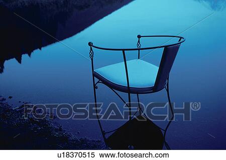 Stock Photography - Chair placed in lake. Tanuki Lake, Shizuoka Prefecture, Japan. Fotosearch