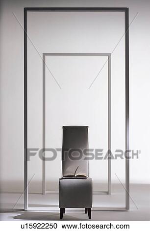 Chair with a book on it surrounded by frames View Large Photo Image Stock Image - Chair with a book on it surrounded by frames. Fotosearch
