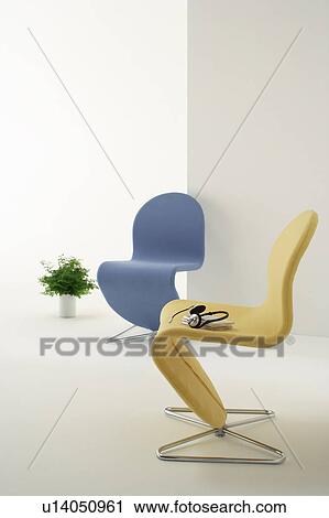 Stock Image - Chair with headphones and potted plant. Fotosearch