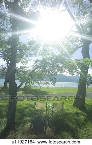 Picture - Chairs in a park by the lake, Towada, Aomori Prefecture, Japan. Fotosearch