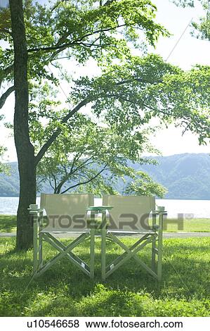 Stock Photo - Chairs in a park by the lake, Towada, Aomori Prefecture, Japan. Fotosearch
