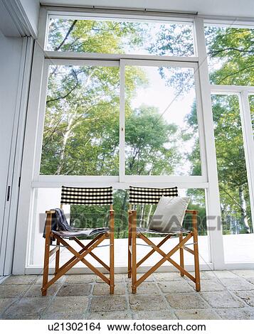 Picture - Chairs in room with large windows. Fotosearch