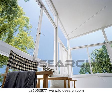 Chairs in room with large windows View Large Photo Image Stock Photo - Chairs in room with large windows. Fotosearch