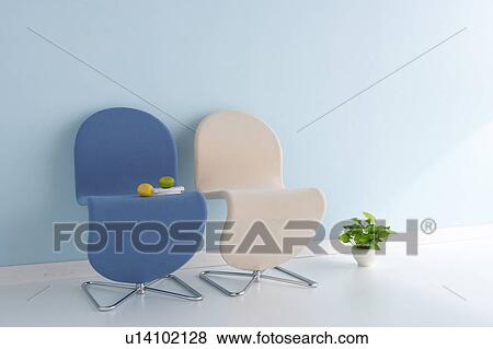 Stock Photo - Chairs next to potted plant. Fotosearch