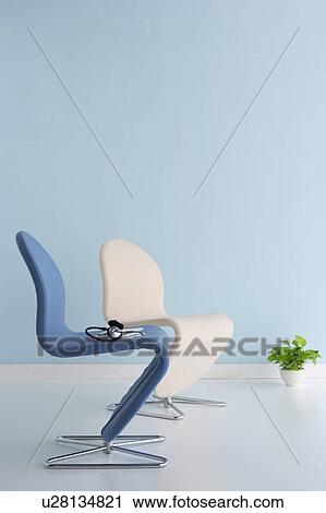 Stock Image - Chairs with headphones on seat. Fotosearch
