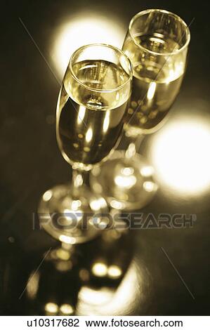 Stock Image - Champagne and Christmas presents. Fotosearch