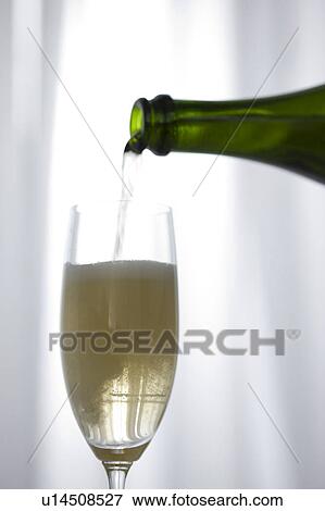 Champagne being poured into champagne flute View Large Photo Image Stock Photo - Champagne being poured into champagne flute. Fotosearch