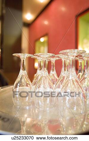 Stock Image - Champagne flutes on silver tray. Fotosearch