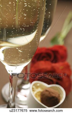Champagne glasses, roses and a gift box of truffles View Large Photo Image Stock Photography - Champagne glasses, roses and a gift box of truffles. Fotosearch