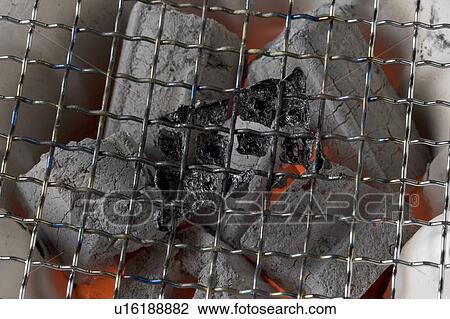 Stock Image - Charcoal fire cooker. Fotosearch