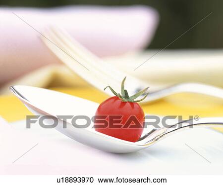 Stock Image - Cherry tomato on a spoon. Fotosearch