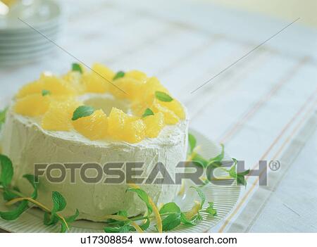 Picture - Chiffon cake with oranges on top. Fotosearch