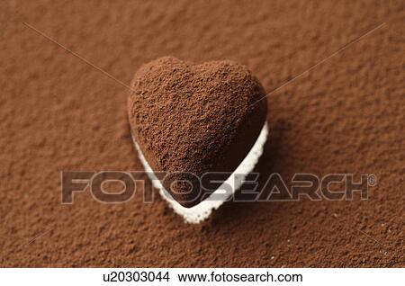 Picture - Chocolate heart covered in cocoa powder. Fotosearch