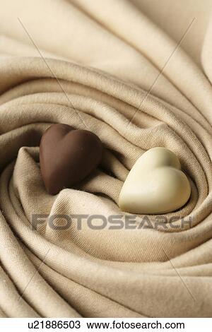 Chocolate hearts on material View Large Photo Image Stock Image - Chocolate hearts on material. Fotosearch