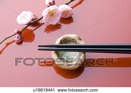 Stock Image - Chopsticks and a plum blossom on a tray. Fotosearch