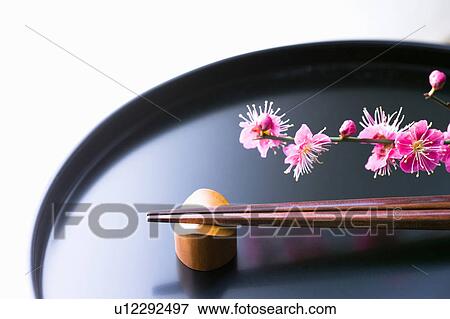 Stock Photo - Chopsticks and a plum blossom on a tray. Fotosearch