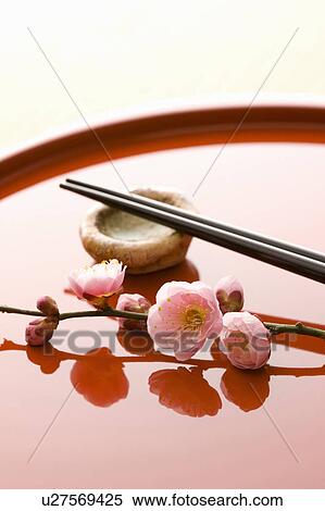 Stock Photography - Chopsticks and a plum blossom on a tray. Fotosearch