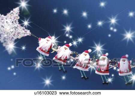 Stock Image - Christmas decorations underneath night sky. Fotosearch