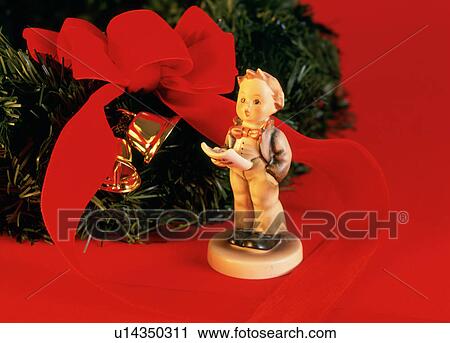 Stock Image - Christmas wreath and choir boy figurine. Fotosearch