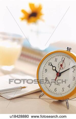 Stock Image - Clock on a desk. Fotosearch